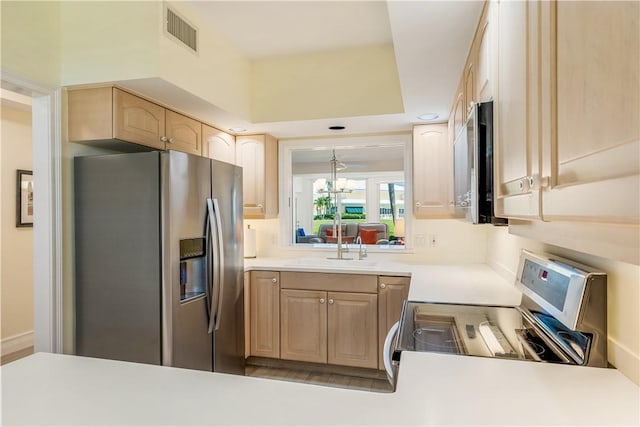 1510 Oak Harbor Blvd Unit 102, Vero Beach, FL 32967 - kitchen with stainless steel appliances, light brown cabinets, a sink, and light countertops