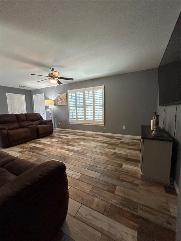 living room featuring ceiling fan and wood finished floors