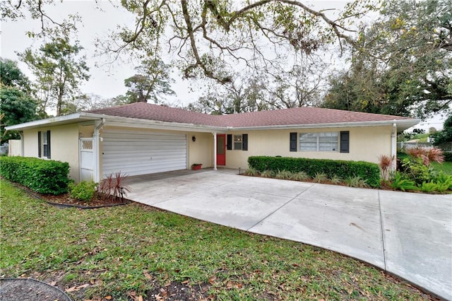 ranch-style home featuring a garage and a front yard