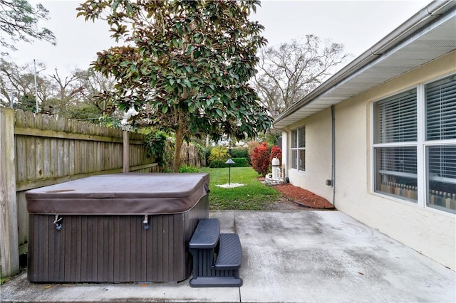 view of patio / terrace with a hot tub