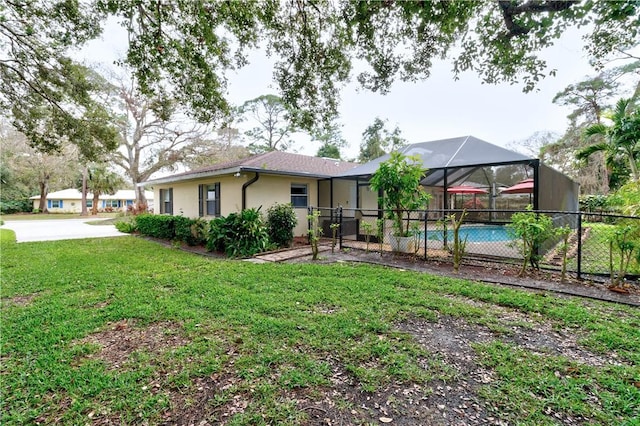 view of yard featuring a fenced in pool and glass enclosure