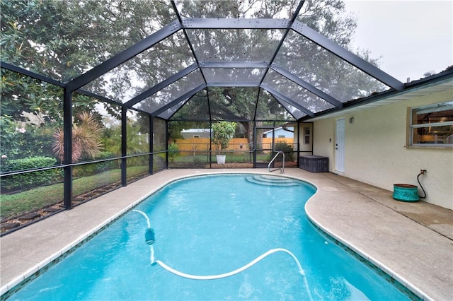 view of swimming pool featuring a lanai and a patio