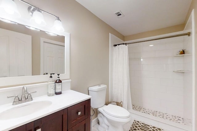 bathroom featuring vanity, toilet, and walk in shower