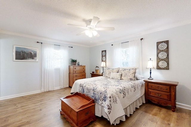 bedroom with multiple windows, light hardwood / wood-style flooring, and ceiling fan