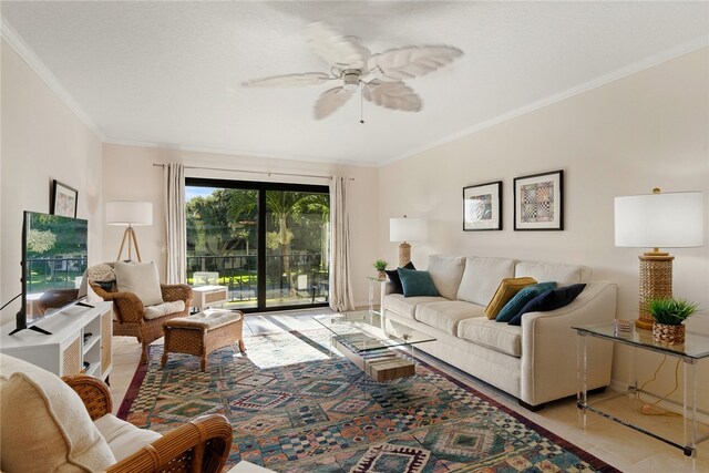 living room featuring ceiling fan, light tile patterned floors, and crown molding