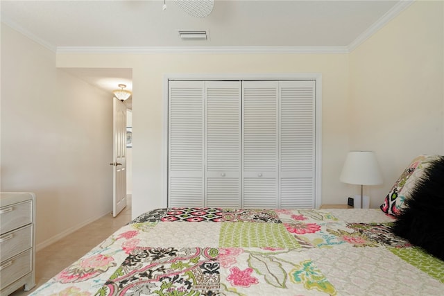 bedroom with light tile patterned floors, ornamental molding, and a closet