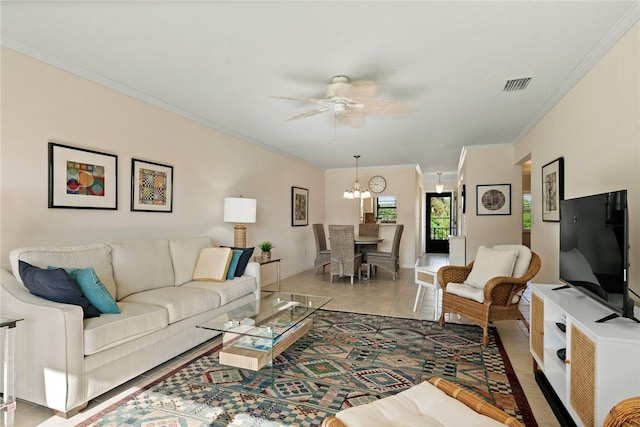 living room with ornamental molding, ceiling fan with notable chandelier, and tile patterned floors