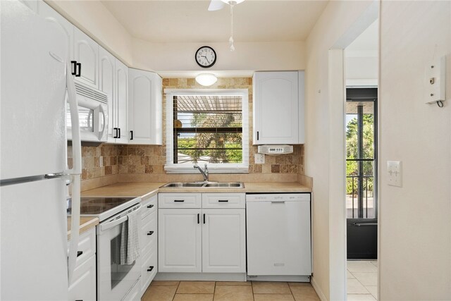 kitchen with white cabinetry, sink, and white appliances