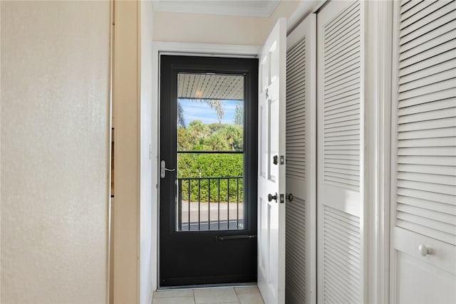 doorway to outside with light tile patterned floors and crown molding