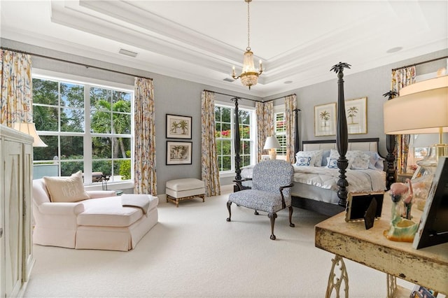 carpeted bedroom with a tray ceiling, crown molding, and an inviting chandelier