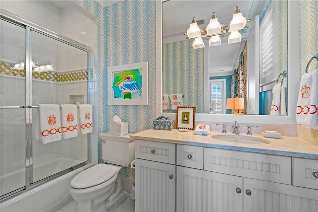 full bathroom with vanity, toilet, and shower / bath combination with glass door