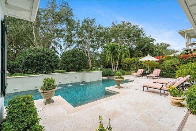 view of pool with pool water feature and a patio