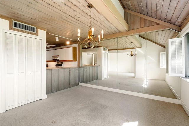 interior space with an inviting chandelier, wood ceiling, track lighting, and carpet