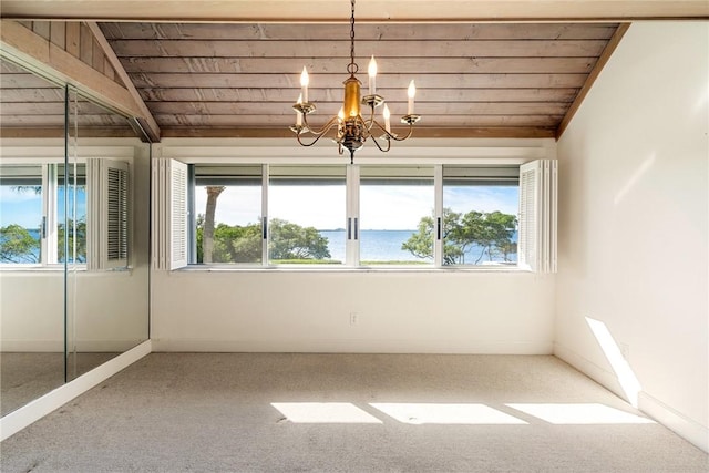 unfurnished room with wood ceiling, lofted ceiling with beams, a chandelier, and carpet flooring