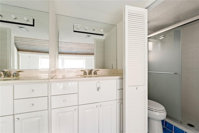 bathroom featuring vanity, an enclosed shower, tile patterned floors, and toilet