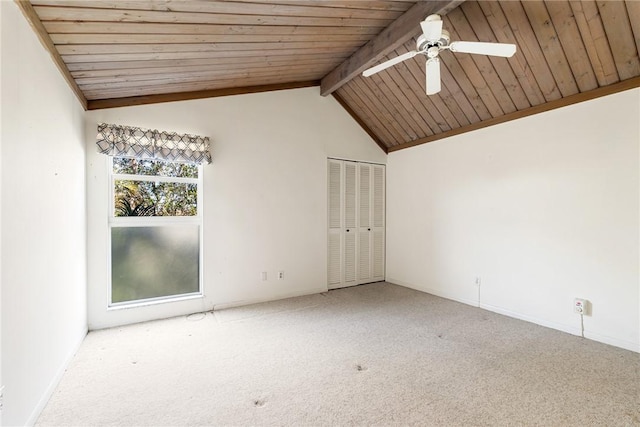 carpeted empty room featuring ceiling fan, wooden ceiling, and vaulted ceiling with beams