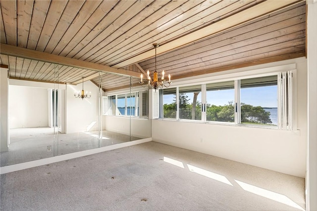 unfurnished sunroom featuring beam ceiling, a water view, wooden ceiling, and a chandelier