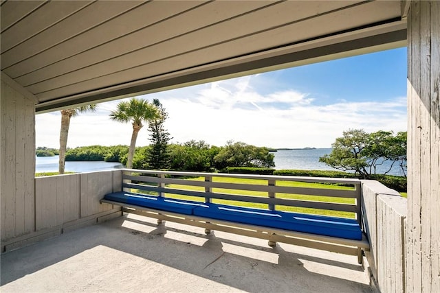 view of patio with a water view and a balcony