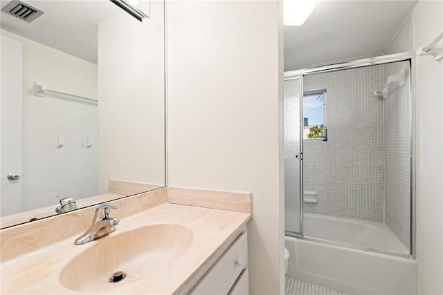 full bathroom with vanity, tile patterned floors, shower / bath combination with glass door, and toilet