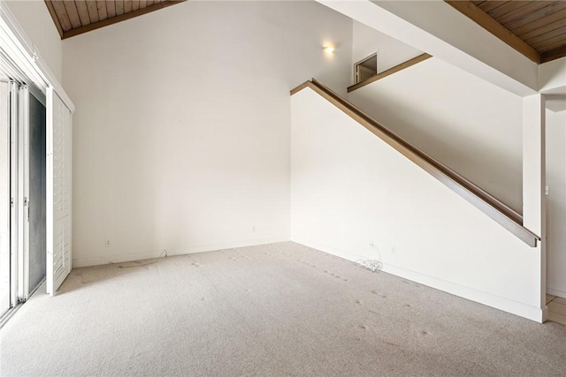 interior space featuring vaulted ceiling, wooden ceiling, and carpet