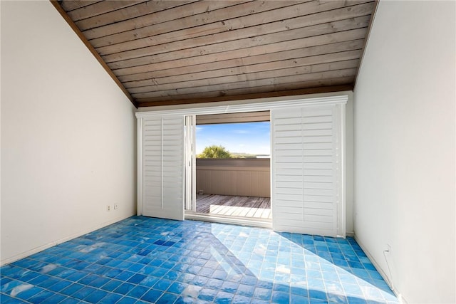 spare room with vaulted ceiling and wooden ceiling