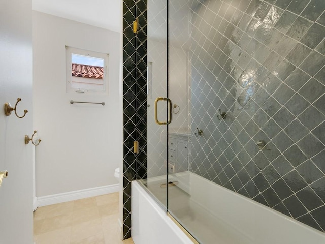 full bath with tile patterned floors, baseboards, and bath / shower combo with glass door