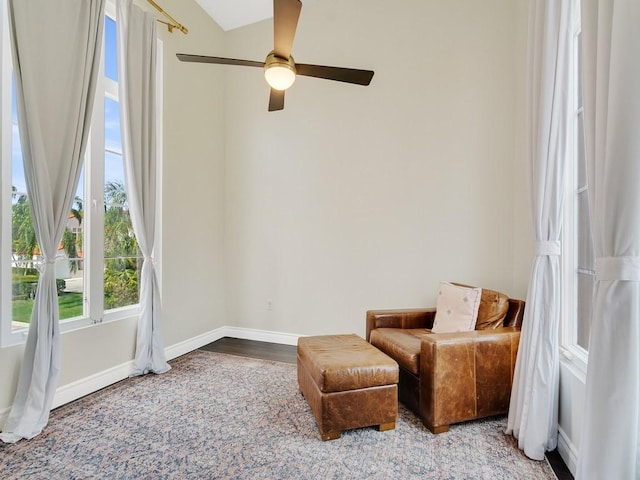 sitting room featuring baseboards, a ceiling fan, and wood finished floors