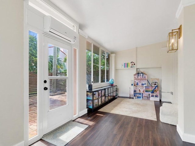 entryway with baseboards, wood finished floors, and a wall mounted air conditioner