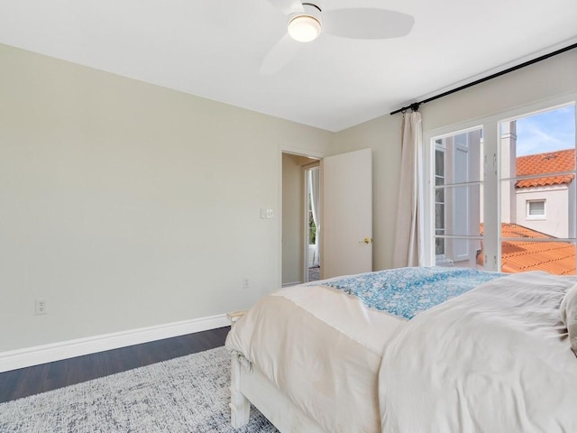 bedroom with ceiling fan, baseboards, and wood finished floors