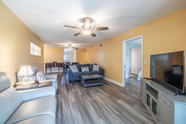 living room with wood-type flooring and ceiling fan