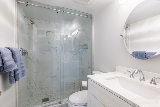 bathroom featuring toilet, vanity, and walk in shower