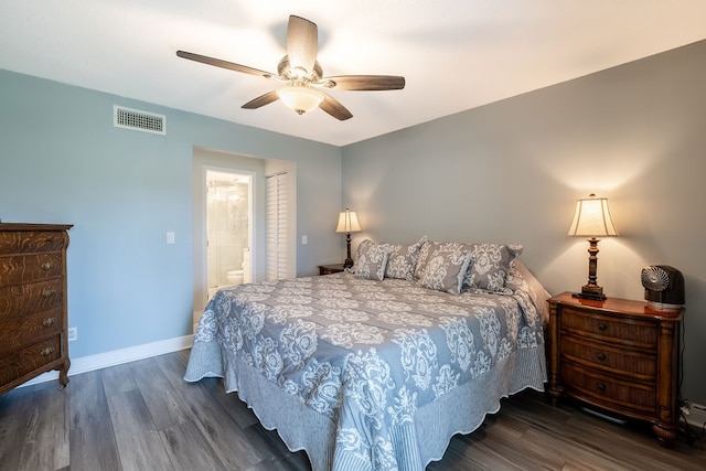 bedroom featuring dark hardwood / wood-style flooring, ceiling fan, and ensuite bath