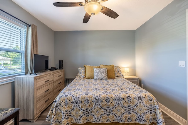 bedroom with hardwood / wood-style floors and ceiling fan