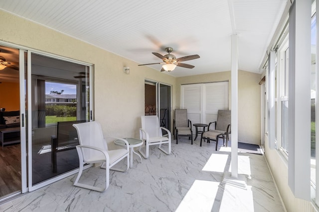 sunroom featuring ceiling fan