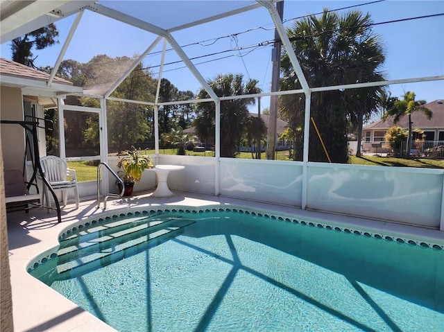 pool featuring a patio area and glass enclosure