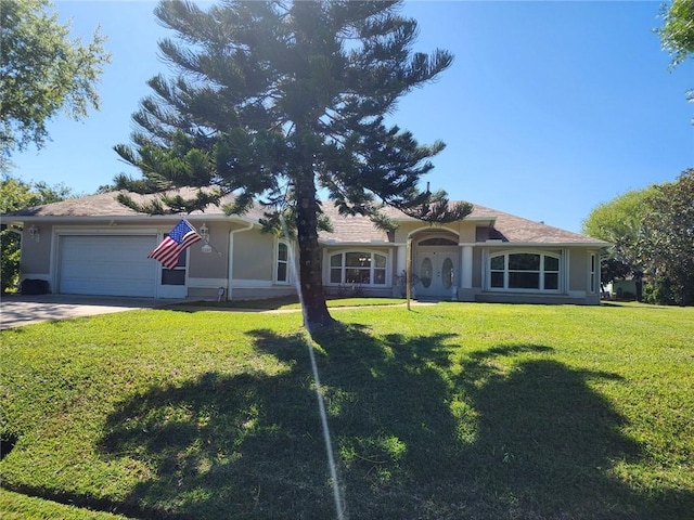 ranch-style home featuring a garage, stucco siding, concrete driveway, and a front yard