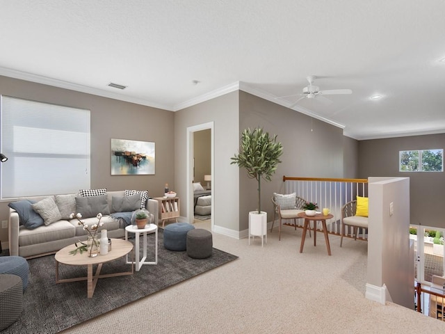 living room featuring crown molding, carpet flooring, and ceiling fan