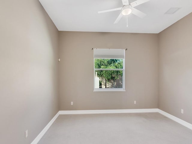 carpeted spare room with ceiling fan