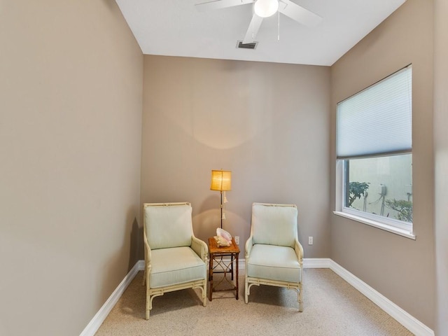 sitting room featuring ceiling fan and carpet