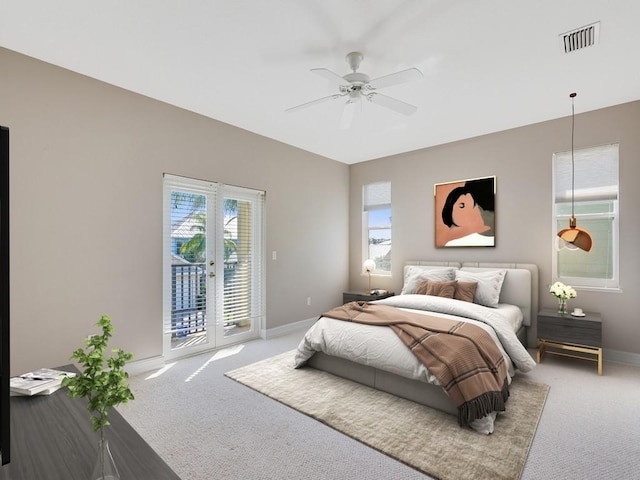 carpeted bedroom with multiple windows, access to exterior, french doors, and ceiling fan