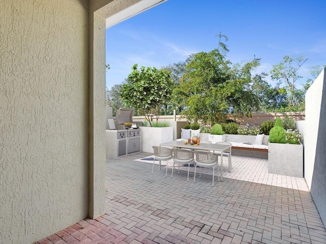 view of patio with an outdoor kitchen and an outdoor hangout area