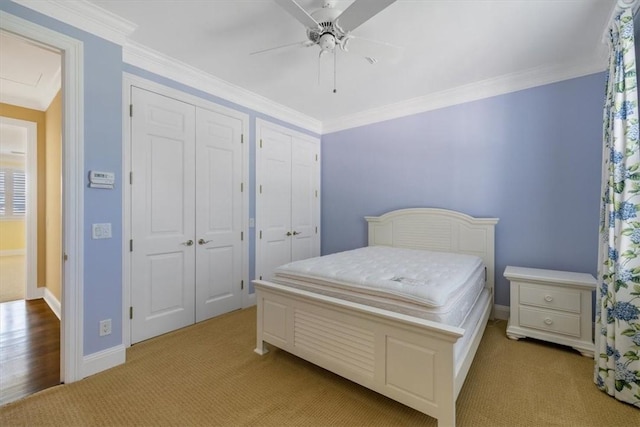 505 Live Oak Rd, Vero Beach, FL 32963 - bedroom with light colored carpet, multiple closets, ceiling fan, crown molding, and multiple windows