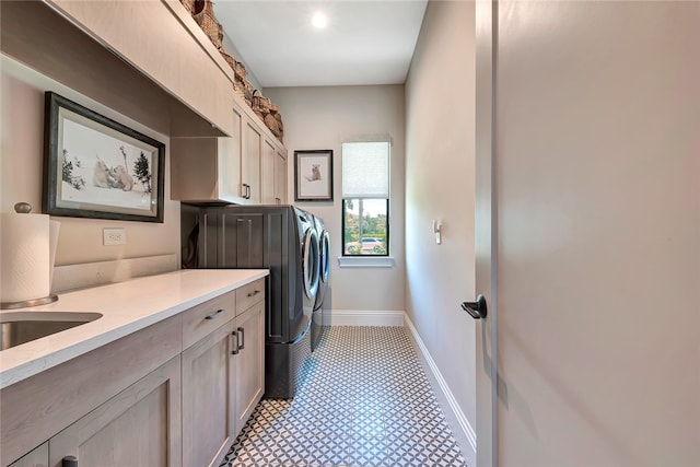 washroom featuring cabinets and washer and clothes dryer