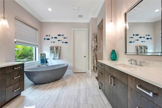 bathroom featuring vanity, a bath, and ornamental molding