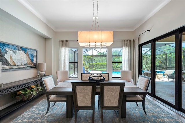 dining room featuring dark hardwood / wood-style floors, crown molding, and an inviting chandelier