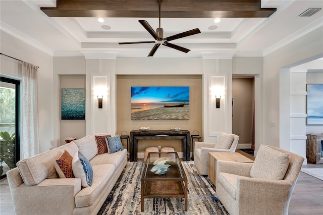 living room featuring beam ceiling, hardwood / wood-style floors, ceiling fan, and crown molding