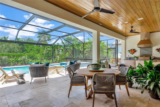 view of patio / terrace featuring glass enclosure, ceiling fan, and pool water feature