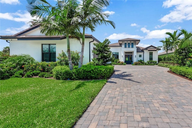 view of front of property featuring a garage and a front lawn