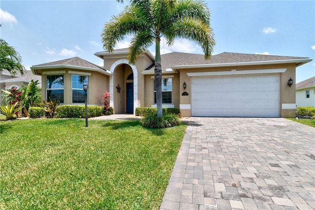 765 Fortunella Cir SW, Vero Beach, FL 32968 - ranch-style home with stucco siding, driveway, a front lawn, and an attached garage