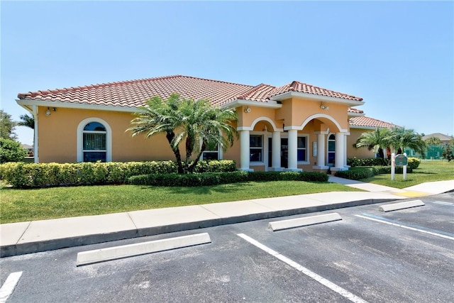 765 Fortunella Cir SW, Vero Beach, FL 32968 - view of front of home with uncovered parking, a tile roof, and a front lawn